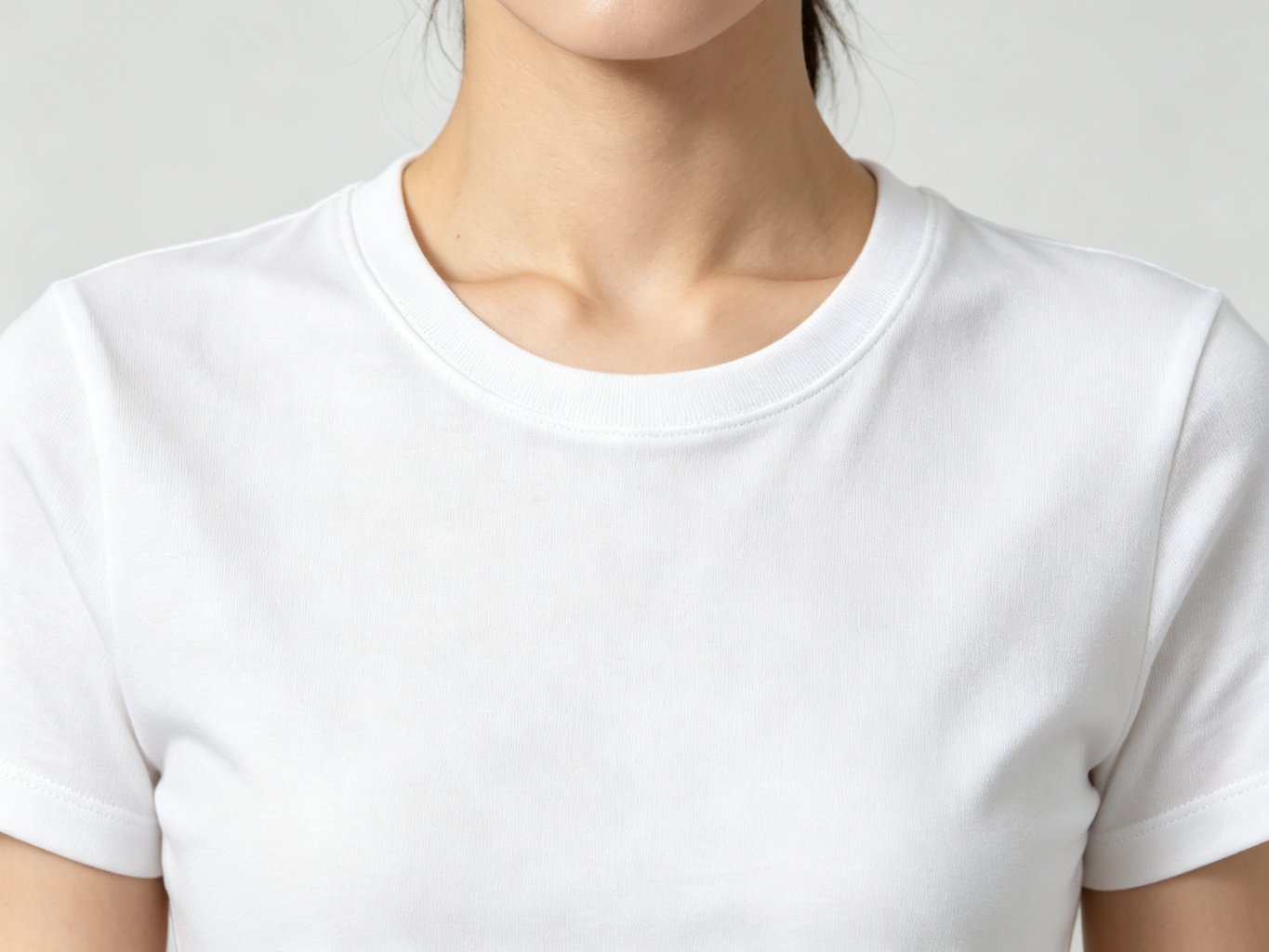 Close-up of the crew neckline on a white cotton basic t-shirt for women